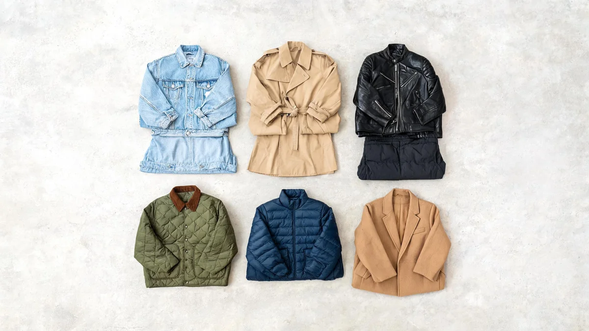 Flat lay of six jackets from lightest to warmest: a denim jacket, khaki trench, black leather jacket, olive quilted jacket, navy packable puffer and camel wool coat